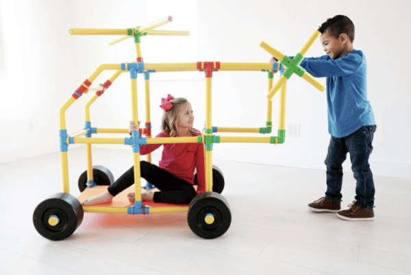 Kids building a colorful structure with Petra Play Ultimate Builder Set, 220 pieces.